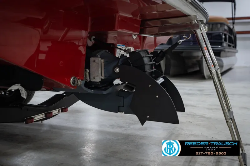 Slide: The Image of 2024 Yamaha Boats AR195 rear view with propeller and ladder in a showroom. - 47