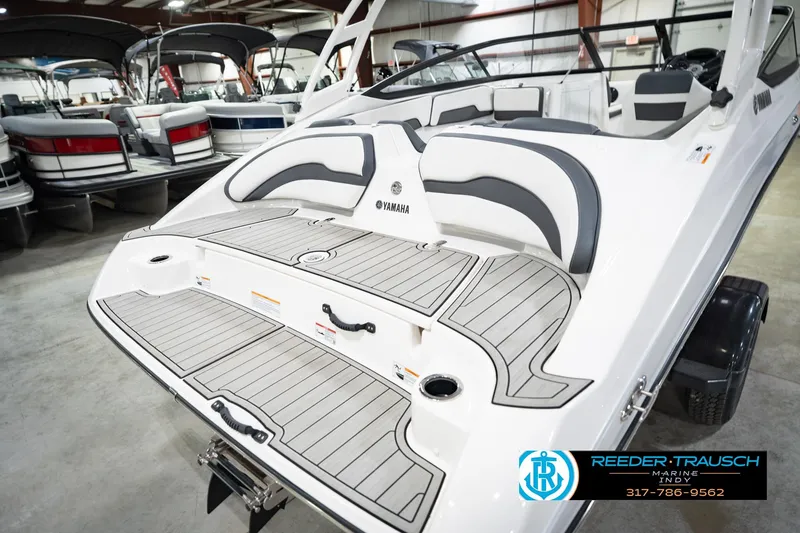Slide: The Image of 2024 Yamaha Boats AR195 in showroom, featuring sleek design and comfortable seating. - 54