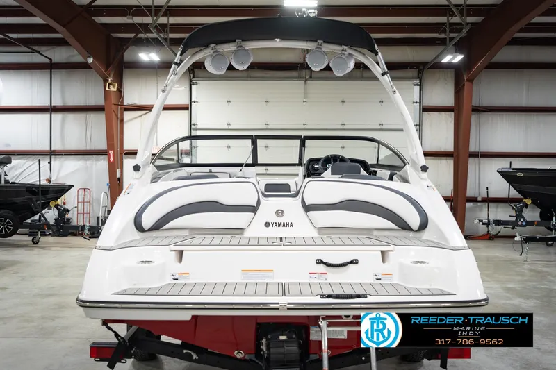 Slide: The Image of 2024 Yamaha AR195 boat in showroom, rear view with sleek design and modern features. - 9