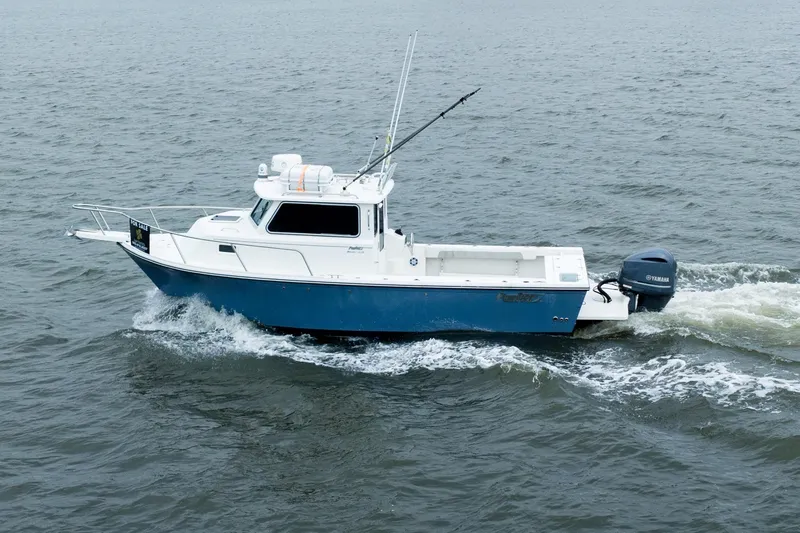 The Image of 2021 Parker 2520 XLD Sport Cabin boat cruising on open water. - 1