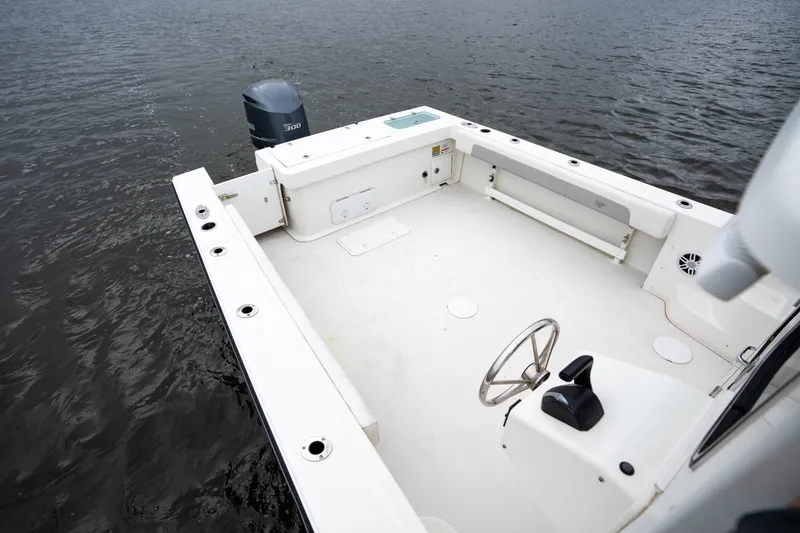 Slide: The Image of 2021 Parker 2520 XLD Sport Cabin boat with spacious deck and outboard motor on water. - 14