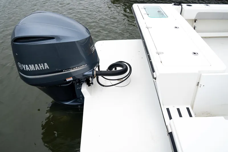 Slide: The Image of 2021 Parker 2520 XLD Sport Cabin with Yamaha outboard motor on water. - 22