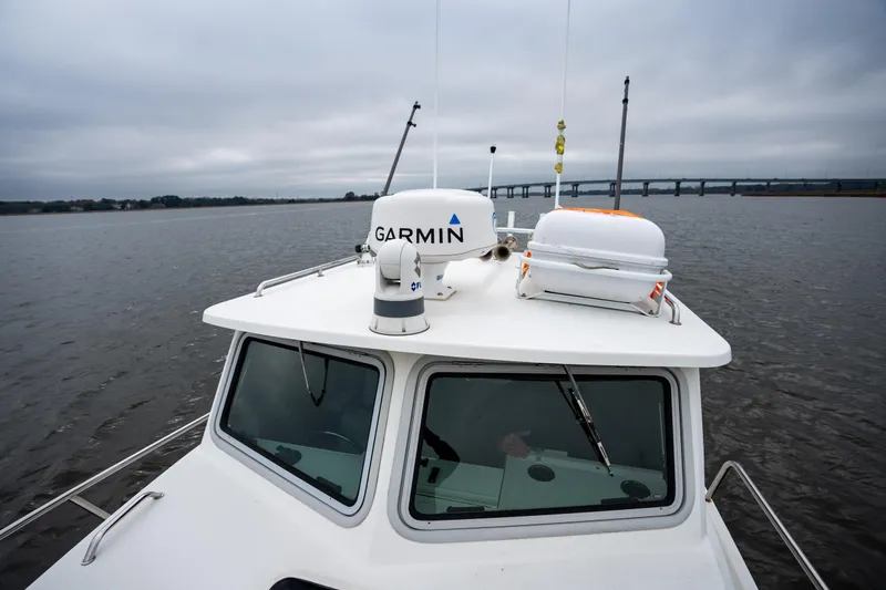 Slide: The Image of 2021 Parker 2520 XLD Sport Cabin boat with Garmin equipment on a cloudy day. - 26