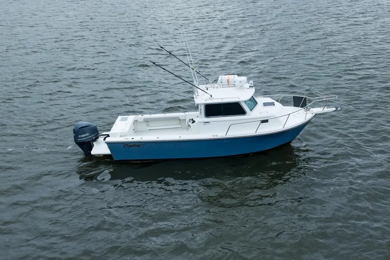 Slide: The Image of 2021 Parker 2520 XLD Sport Cabin boat on open water, featuring a Yamaha outboard motor. - 3