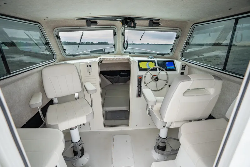 Slide: The Image of 2021 Parker 2520 XLD Sport Cabin interior with steering wheel and navigation screens. - 30
