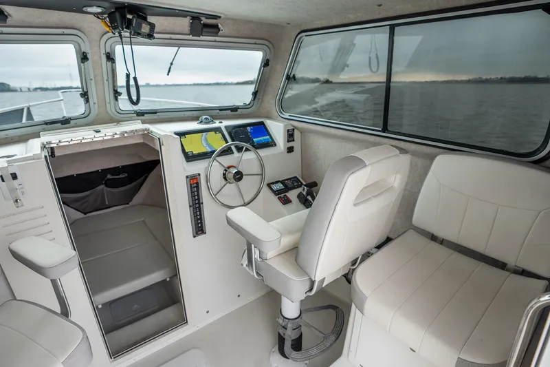 Slide: The Image of 2021 Parker 2520 XLD Sport Cabin interior with steering wheel and navigation equipment. - 31