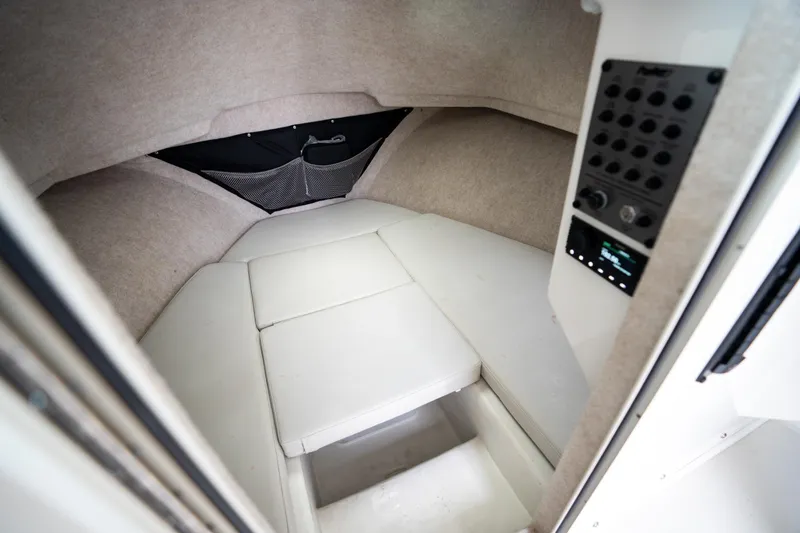 Slide: The Image of Interior cabin of 2021 Parker 2520 XLD Sport Cabin boat, featuring cushioned seating. - 34