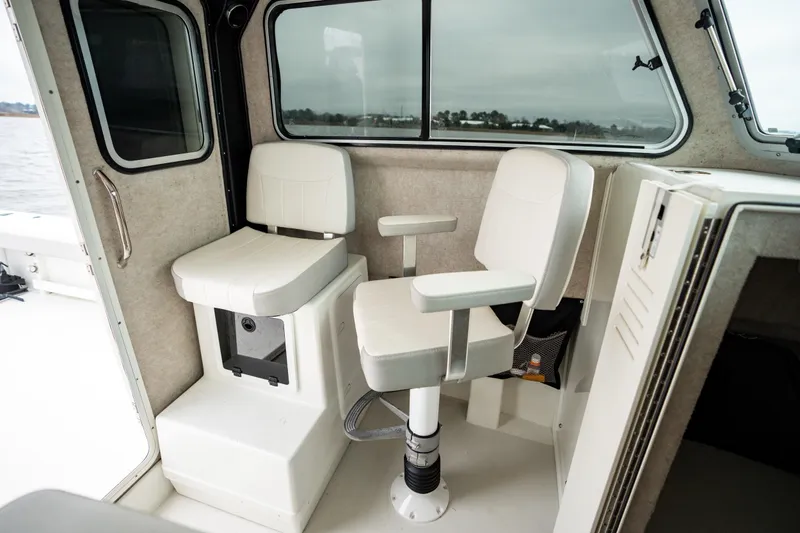 Slide: The Image of 2021 Parker 2520 XLD Sport Cabin interior with two white seats and large windows. - 36