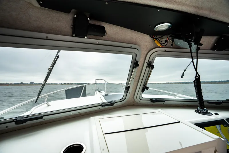 Slide: The Image of Interior view from a 2021 Parker 2520 XLD Sport Cabin boat, overlooking the water. - 44