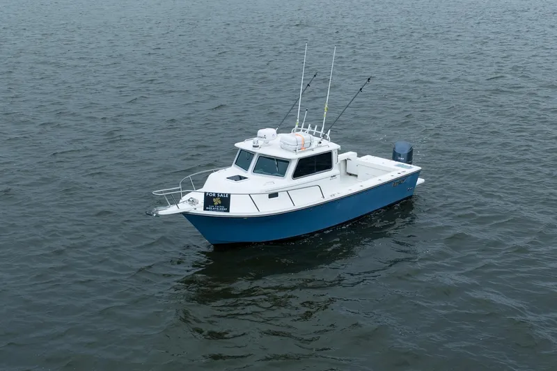 Slide: The Image of 2021 Parker 2520 XLD Sport Cabin boat for sale on open water. - 5