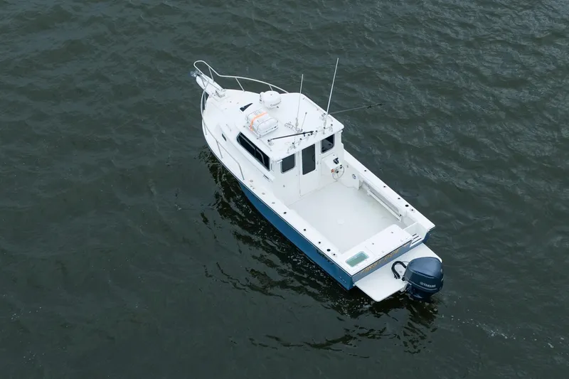 Slide: The Image of 2021 Parker 2520 XLD Sport Cabin boat on open water, aerial view. - 6
