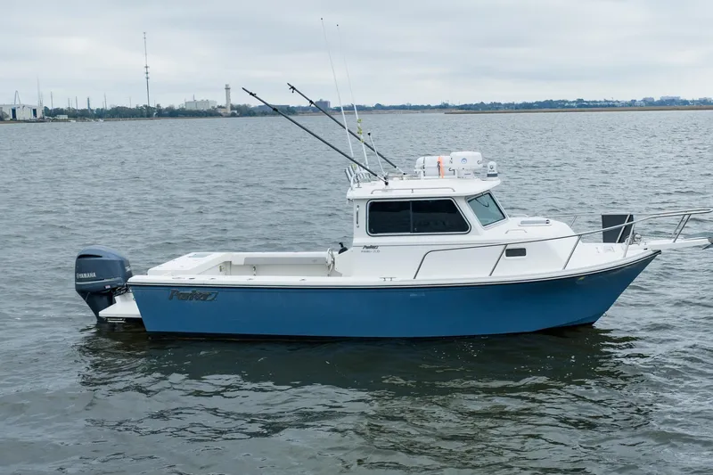 Slide: The Image of 2021 Parker 2520 XLD Sport Cabin boat on calm water, side view. - 8