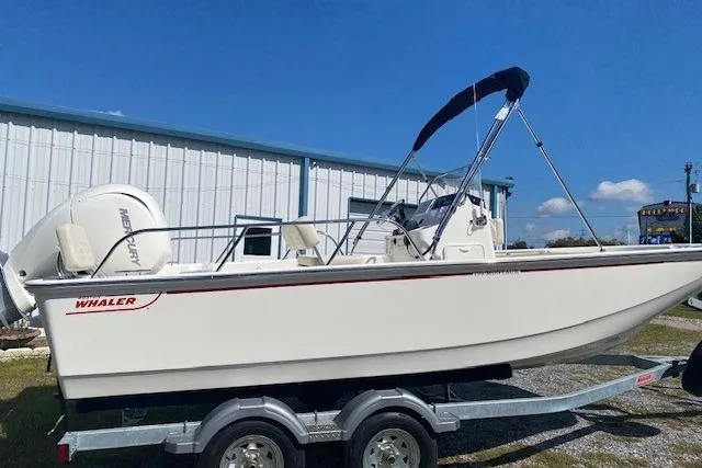 The Image of 2026 Boston Whaler 190 Montauk boat on trailer, parked outdoors under clear blue sky. - 0