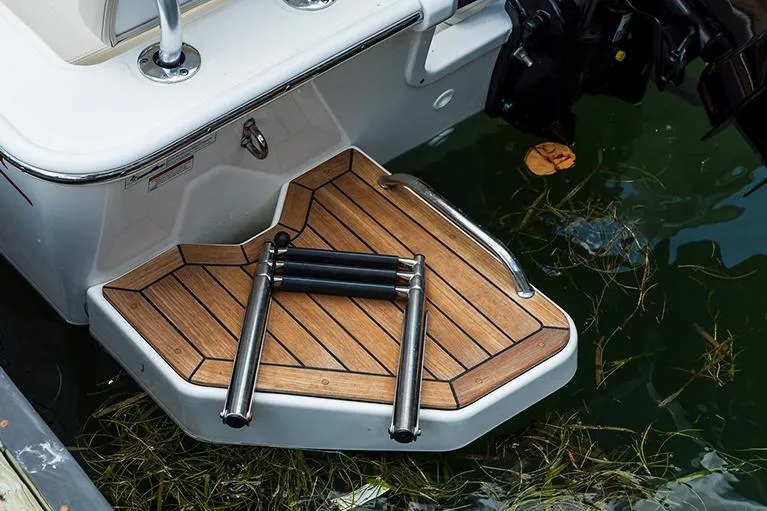 Slide: The Image of Manufacturer Provided Image: 2026 Boston Whaler 190 Montauk swim platform with ladder, docked in water. - 6