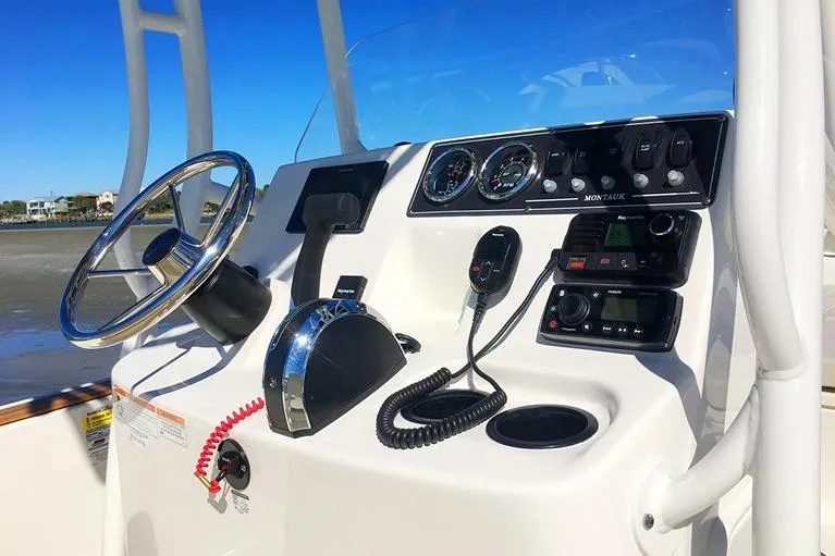 Slide: The Image of Manufacturer Provided Image: 2026 Boston Whaler 190 Montauk boat dashboard with steering wheel and controls. - 9