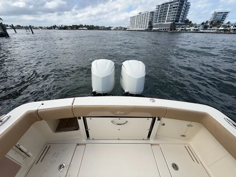 Slide: The Image of Rear view of a 2017 Scout 320 LXF boat on the water. - 11