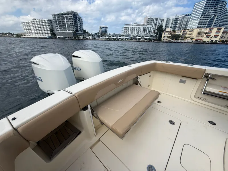 Slide: The Image of 2017 Scout 320 LXF with Yamaha engines, overlooking water and buildings. - 12