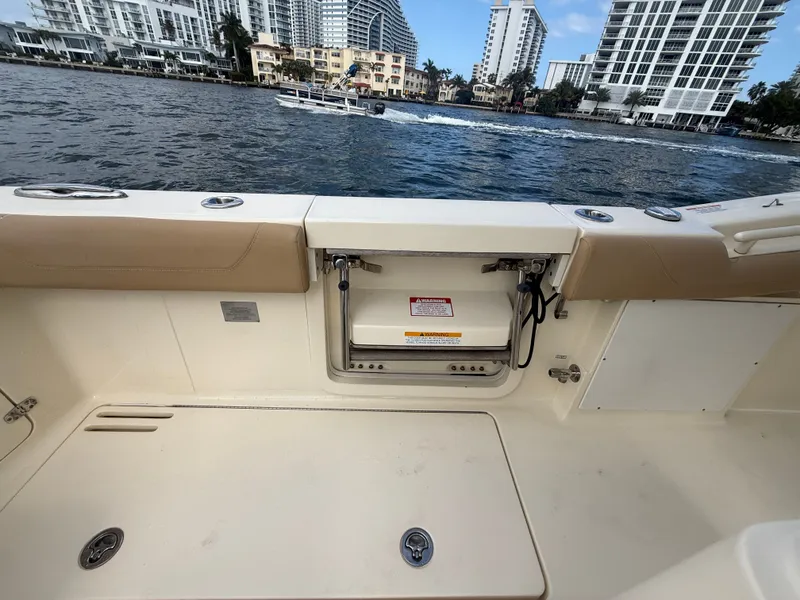 Slide: The Image of Interior view of a 2017 Scout 320 LXF boat by the water. - 14