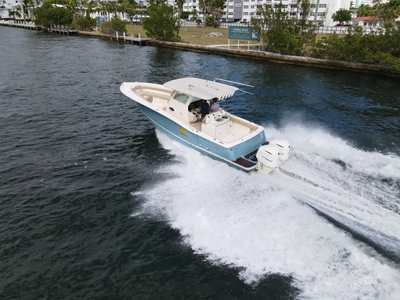 Slide: The Image of 2017 Scout 320 LXF boat cruising swiftly on water. - 18