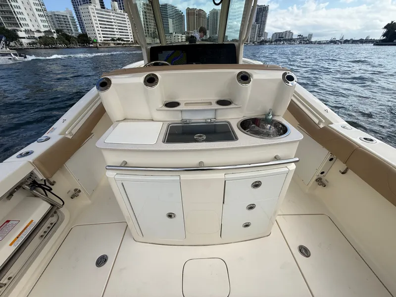Slide: The Image of Interior view of a 2017 Scout 320 LXF boat with cityscape background. - 8