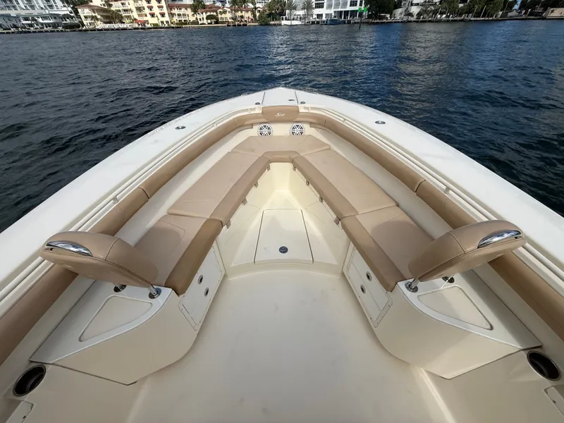 Slide: The Image of Scout 320 LXF 2017 boat with beige seating area on the water. - 9