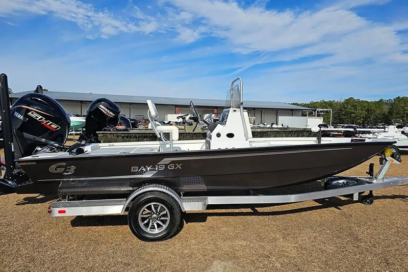 The Image of 2025 G3 Bay 19 GX boat on trailer, featuring Yamaha engine, under clear blue sky. - 1