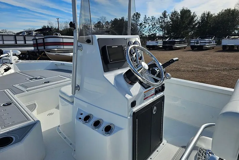 Slide: The Image of 2025 G3 Bay 19 GX boat console with steering wheel and controls, parked outdoors. - 11