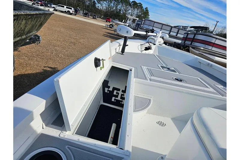 Slide: The Image of 2025 G3 Bay 19 GX boat interior with open storage compartment and fishing equipment. - 13