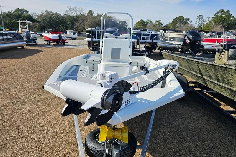 Slide: The Image of 2025 G3 Bay 19 GX boat with trolling motor, displayed outdoors among other boats. - 4