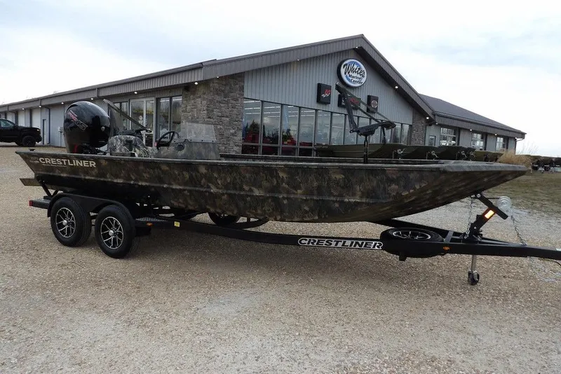 The Image of 2026 Crestliner 2070 Retriever SCHD boat on trailer outside dealership. - 1