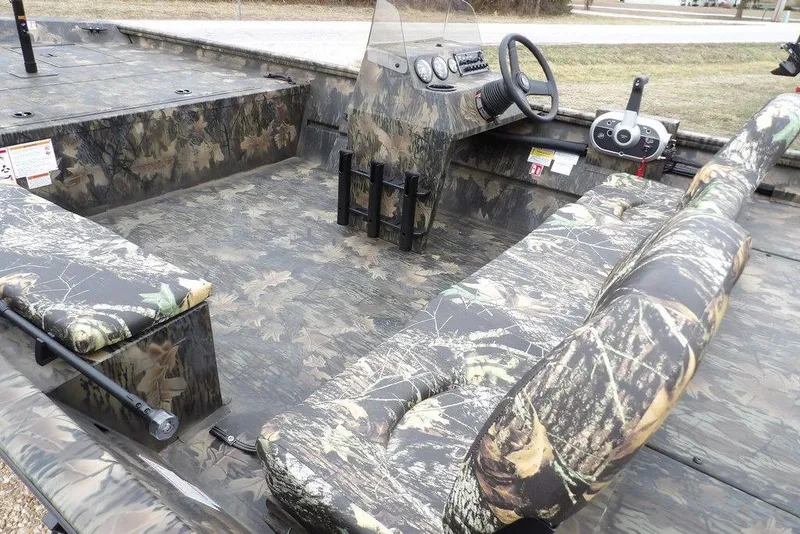 Slide: The Image of 2026 Crestliner 2070 Retriever SCHD boat with camouflage interior and steering console. - 10