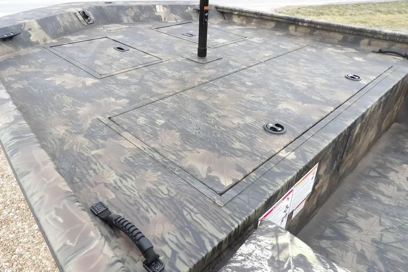 Slide: The Image of 2026 Crestliner 2070 Retriever SCHD boat with camouflage deck and storage compartments. - 12