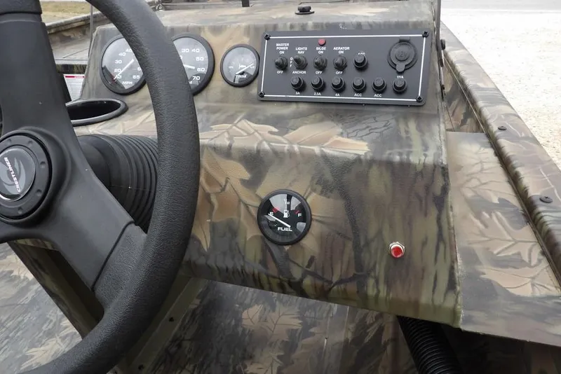 Slide: The Image of Crestliner 2070 Retriever SCHD 2026 dashboard with camouflage design and control panel. - 16