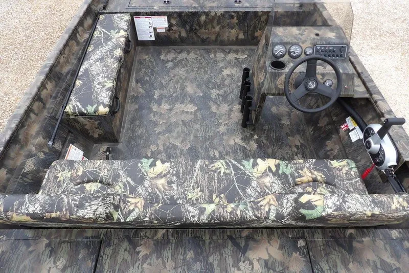 Slide: The Image of 2026 Crestliner 2070 Retriever SCHD boat interior with camouflage design and steering console. - 18