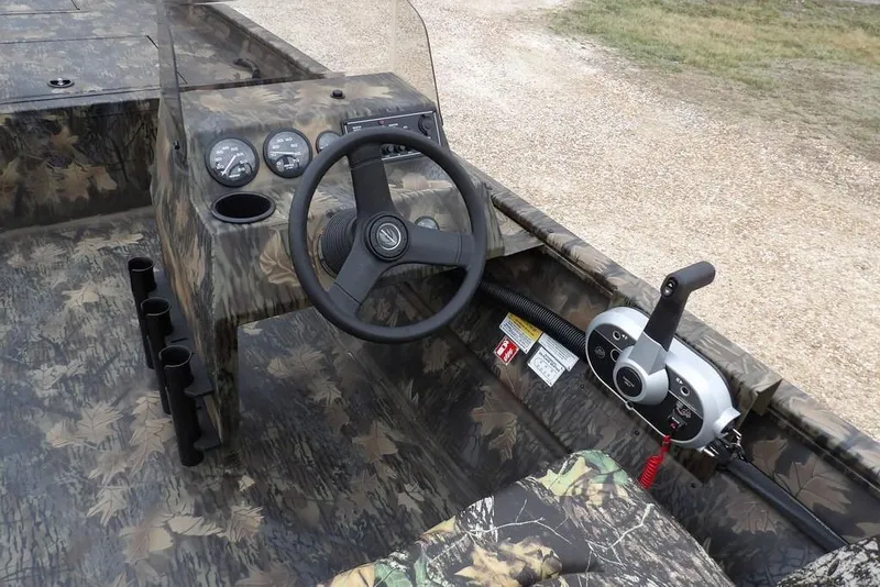 Slide: The Image of 2026 Crestliner 2070 Retriever SCHD boat interior with camouflage design and steering console. - 20