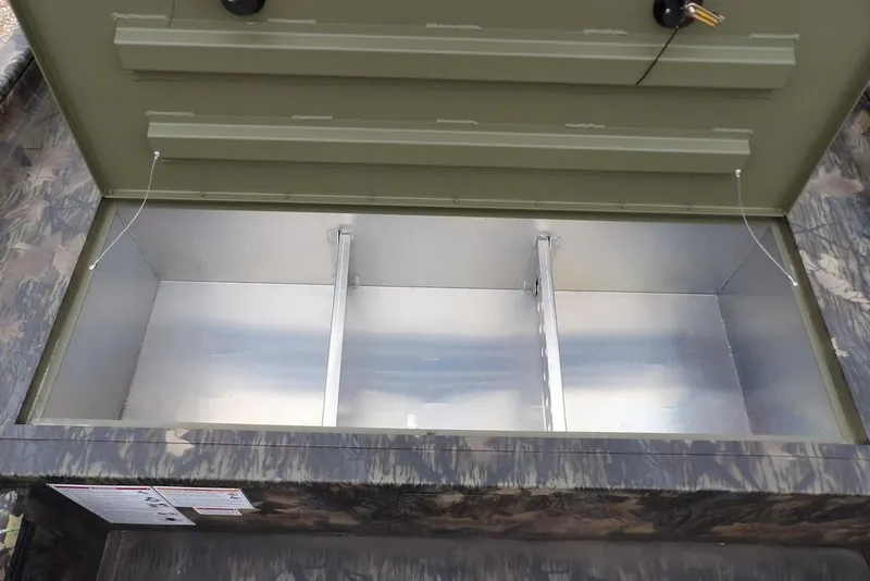 Slide: The Image of Open storage compartment of 2026 Crestliner 2070 Retriever SCHD boat, featuring a camo design. - 22