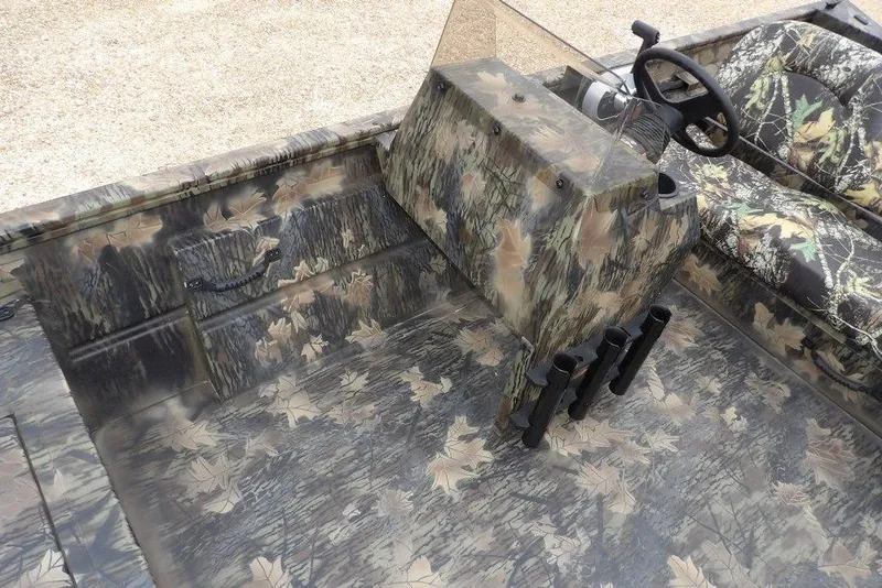 Slide: The Image of 2026 Crestliner 2070 Retriever SCHD boat interior with camouflage design and steering console. - 24