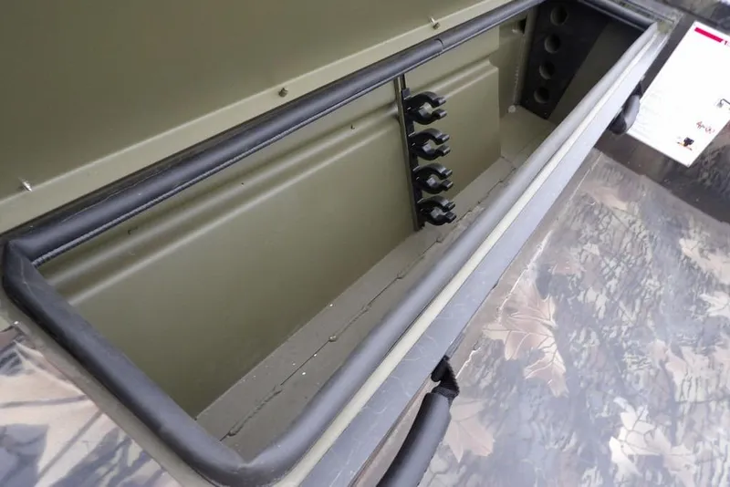 Slide: The Image of Storage compartment of 2026 Crestliner 2070 Retriever SCHD boat, featuring rod holders. - 25