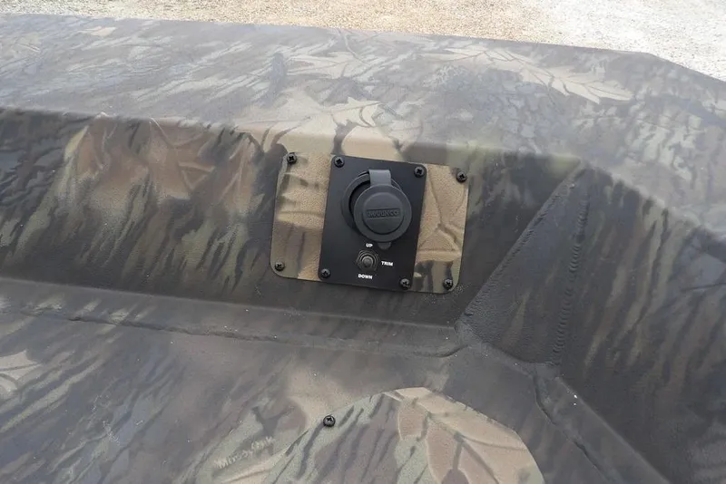 Slide: The Image of 2026 Crestliner 2070 Retriever SCHD boat with camouflage pattern and control panel. - 26