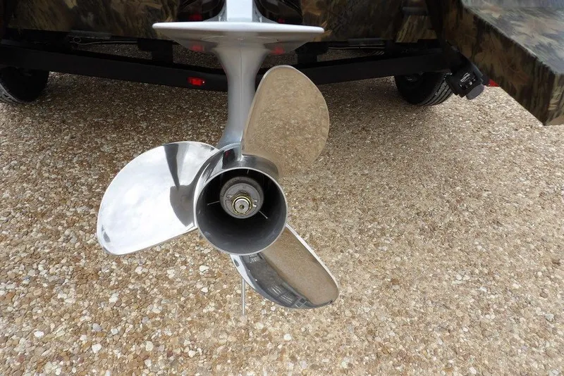 Slide: The Image of Propeller of 2026 Crestliner 2070 Retriever SCHD boat on gravel surface. - 31