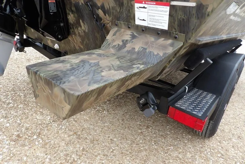 Slide: The Image of 2026 Crestliner 2070 Retriever SCHD boat with camouflage design on a trailer. - 32
