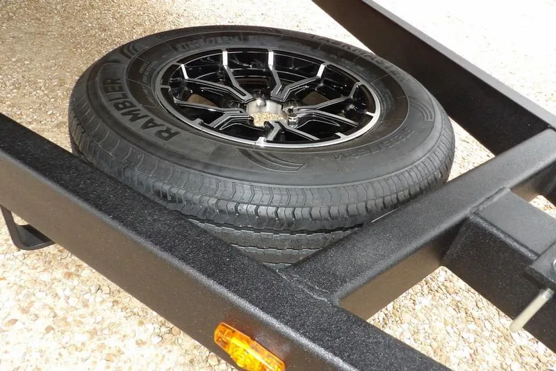 Slide: The Image of Spare tire on Crestliner 2070 Retriever SCHD trailer, featuring Rambler tire and black alloy wheel. - 35