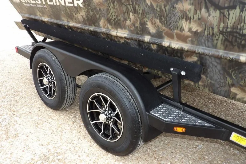Slide: The Image of 2026 Crestliner 2070 Retriever SCHD trailer with camouflage design and dual black wheels. - 36