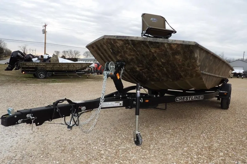Slide: The Image of 2026 Crestliner 2070 Retriever SCHD boat on trailer, camo design, parked outdoors. - 37