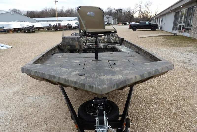 Slide: The Image of 2026 Crestliner 2070 Retriever SCHD boat with camouflage design on a trailer. - 4