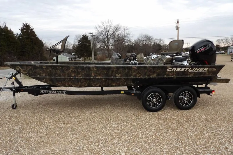 Slide: The Image of 2026 Crestliner 2070 Retriever SCHD boat on trailer, camo design, parked outdoors. - 5