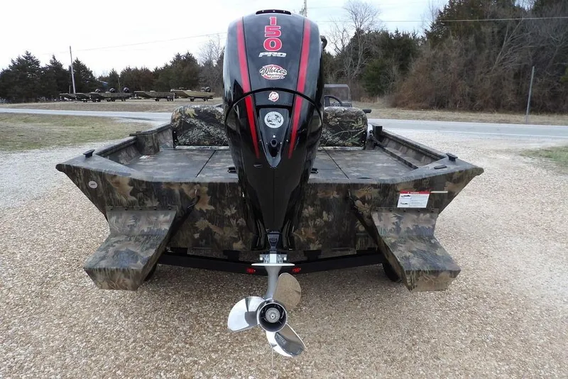 Slide: The Image of 2026 Crestliner 2070 Retriever SCHD boat with camo design and powerful outboard motor. - 6