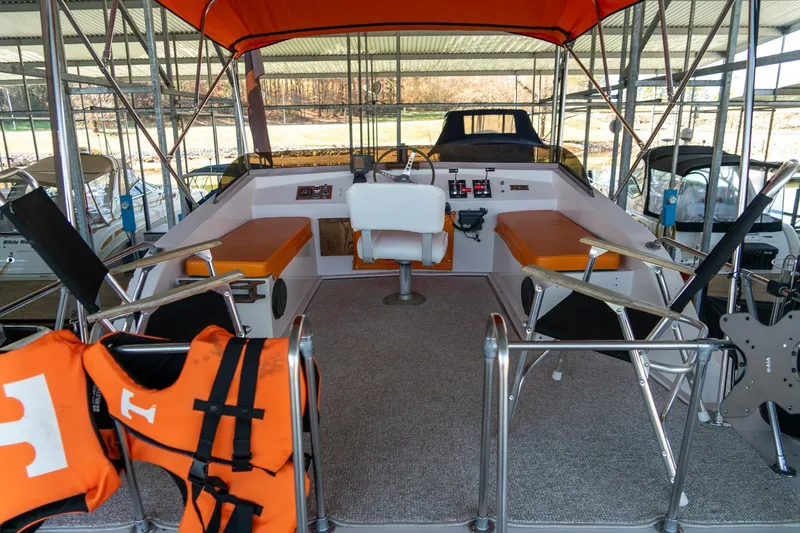 Slide: The Image of 1974 Boatel 47 Islander boat interior with orange canopy and seating. - 12