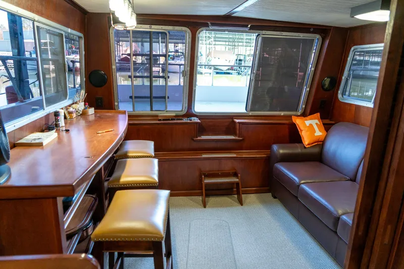 Slide: The Image of 1974 Boatel 47 Islander interior with bar, stools, and leather sofa. - 14