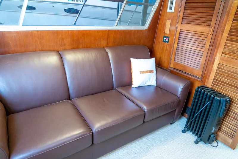 Slide: The Image of Brown leather sofa in 1974 Boatel 47 Islander interior with Tennessee pillow and wooden paneling. - 15